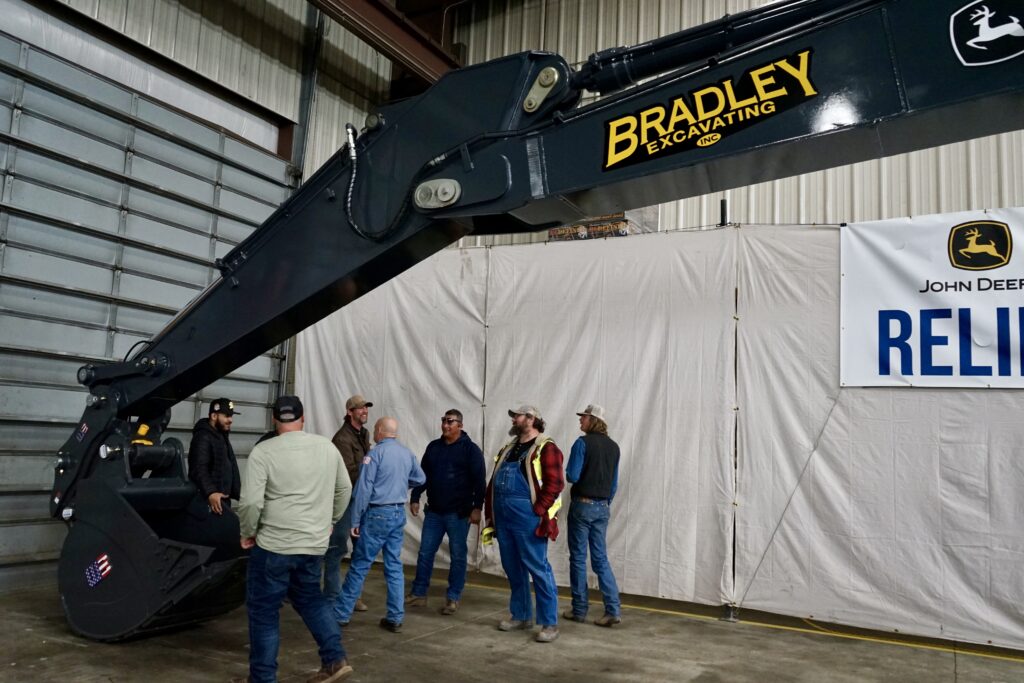 The crew at Bradley Excavating checks out fully rebuilt excavator. 