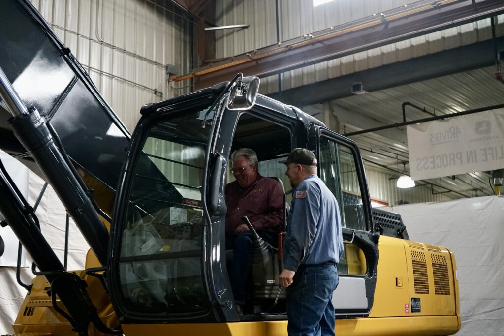 The crew at Bradley Excavating checks out fully rebuilt excavator. 