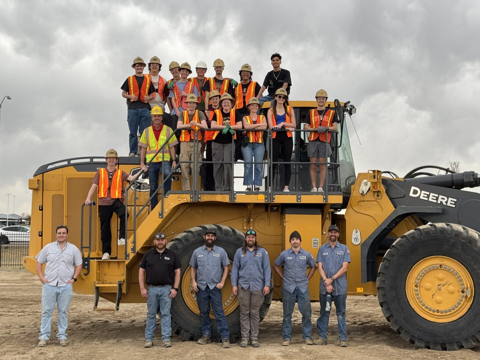Engineering Equipment Rodeo students with 4Rivers staff beside a piece of machinery.