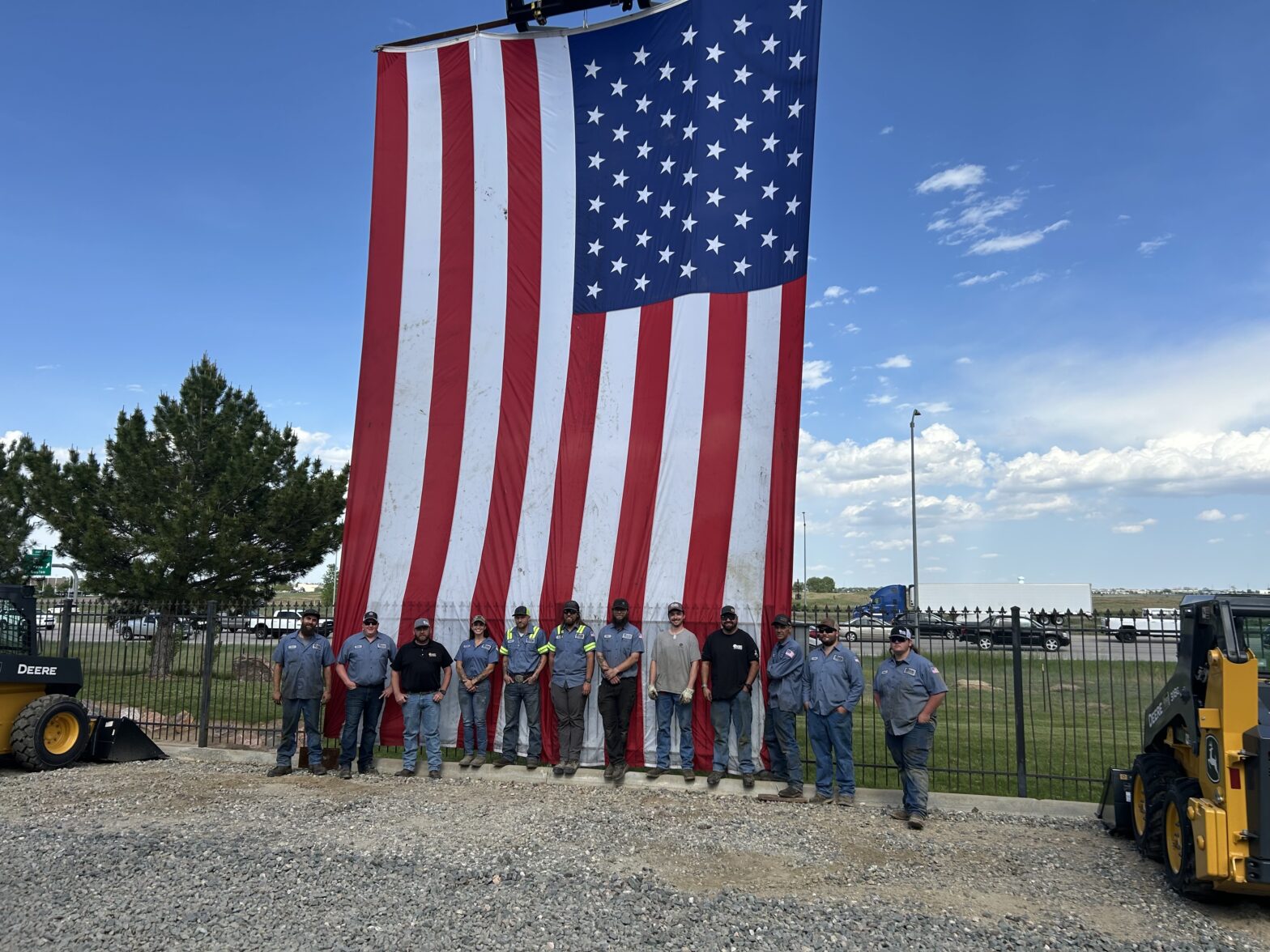 Staff from 4Rivers in Frederick in front of an enormous American flag.